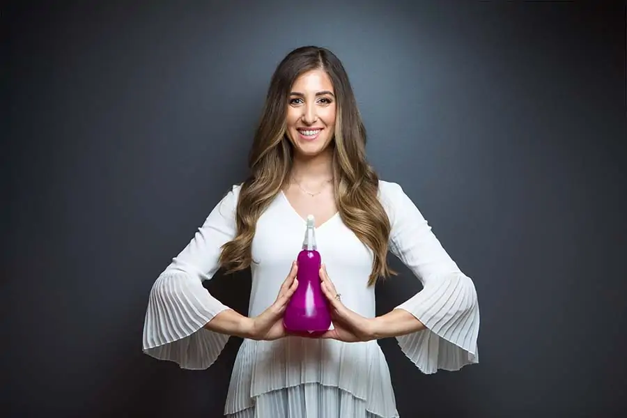 Melissa Maker Holding Spray Bottle